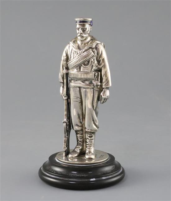 A late Victorian novelty silver and enamel inkwell, modelled as a sailor from HMS Duke of Wellington, overall 17cm.